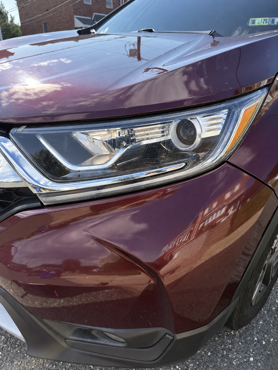 Clear headlight on the same burgundy SUV after restoration